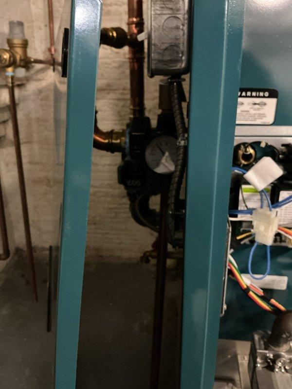 Performed a tune-up on a one-year-old gas-fired boiler, inspecting the burner assembly, gas manifold and orifices, ignitor/flame sensor, and associated wiring, and clearing dust and debris from the burner compartment. Verified the circulator pump, pressure/temperature gauge, relief valve and discharge piping, copper connections, and gas valve for proper condition, with no leaks, rust, or damage observed. System was left in good operating condition.