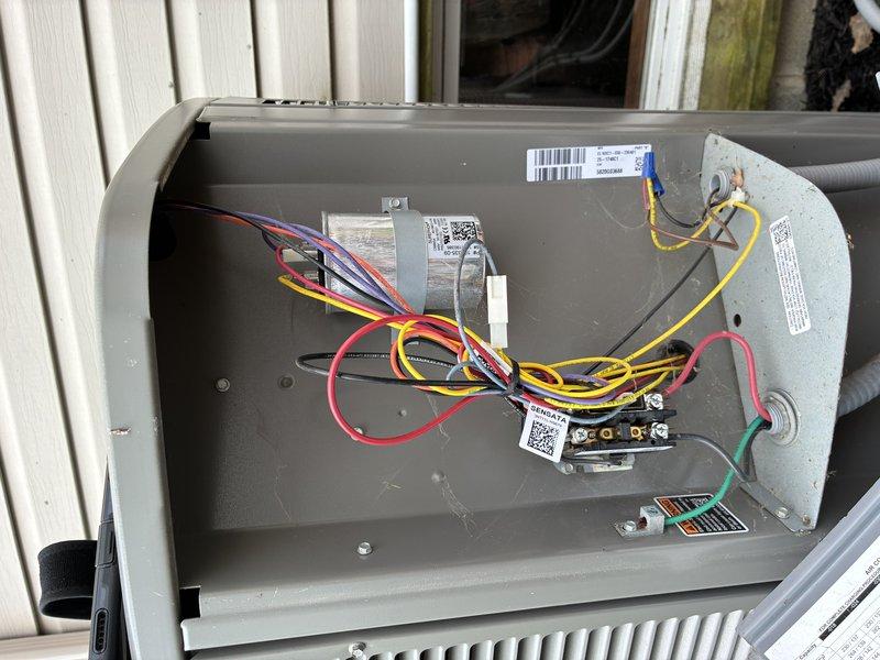 Performed a cooling maintenance inspection on the outdoor condenser unit, including removal of the control panel access cover to inspect the capacitor, contactor, and high- and low-voltage wiring connections, with all components found clean and free of corrosion, damage, or visible wear. Verified the grounding connection, refrigerant line and conduit routing, and the exterior unit housing, finding no signs of frost, rust, or breakage, and the system was left in proper operating condition.