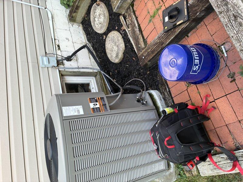 Performed a cooling maintenance inspection on the outdoor condenser unit, including removal of the control panel access cover to inspect the capacitor, contactor, and high- and low-voltage wiring connections, with all components found clean and free of corrosion, damage, or visible wear. Verified the grounding connection, refrigerant line and conduit routing, and the exterior unit housing, finding no signs of frost, rust, or breakage, and the system was left in proper operating condition.