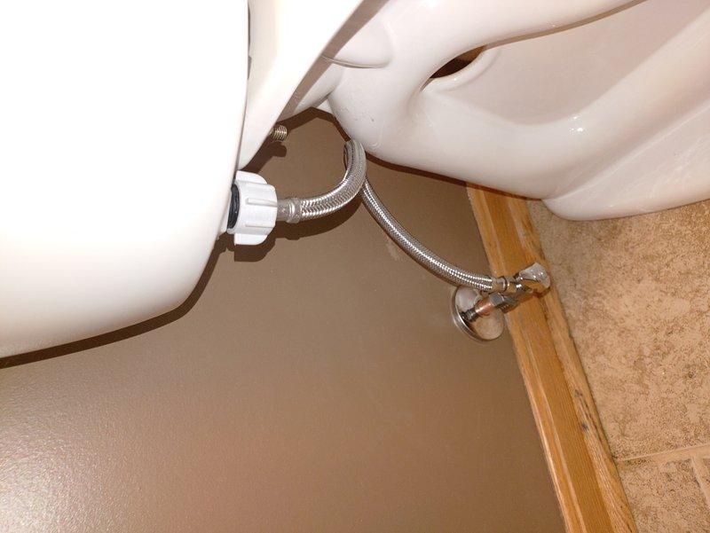 Removed the corroded, deteriorated toilet flange and accessed the drain line from the basement using a fitting saver tool in the confined space. Installed new 3" ABS drain piping to a new stainless steel banded flange, secured it to the bathroom floor, and reset the toilet with a new wax ring and closet bolts.
