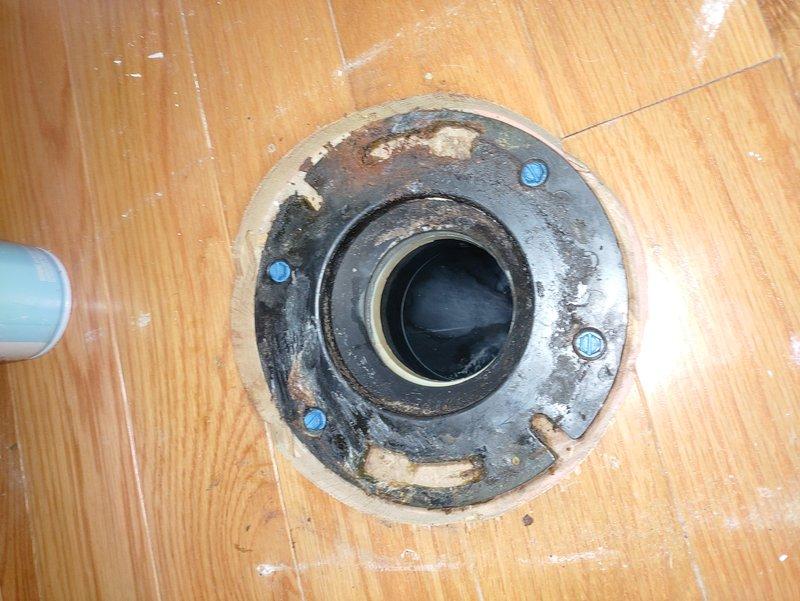 Removed the corroded, deteriorated toilet flange and accessed the drain line from the basement using a fitting saver tool in the confined space. Installed new 3" ABS drain piping to a new stainless steel banded flange, secured it to the bathroom floor, and reset the toilet with a new wax ring and closet bolts.