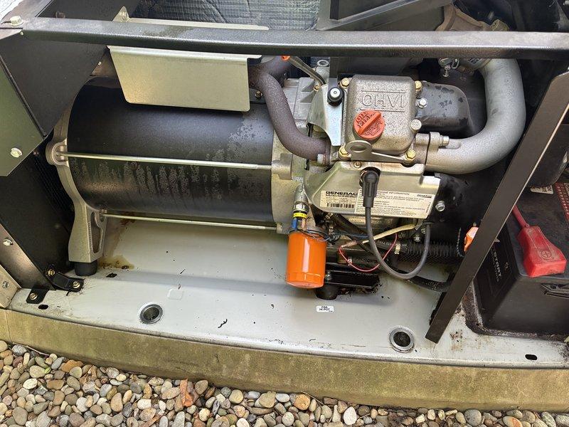 Responded to a service call for a standby generator that had shut down with a fault indicator illuminated following recent maintenance, while the second unit operated normally. Inspected the generator enclosure, including the engine compartment, alternator housing, oil filter, battery connections, wiring, and base pan, and documented the unit's condition with photos. Findings and any further corrective action should be confirmed before closing the work order.