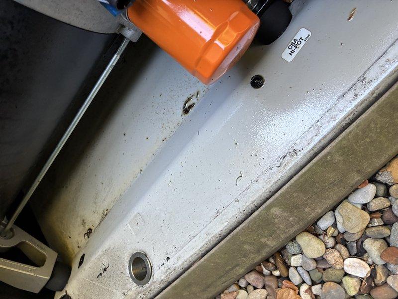 Responded to a service call for a standby generator that had shut down with a fault indicator illuminated following recent maintenance, while the second unit operated normally. Inspected the generator enclosure, including the engine compartment, alternator housing, oil filter, battery connections, wiring, and base pan, and documented the unit's condition with photos. Findings and any further corrective action should be confirmed before closing the work order.