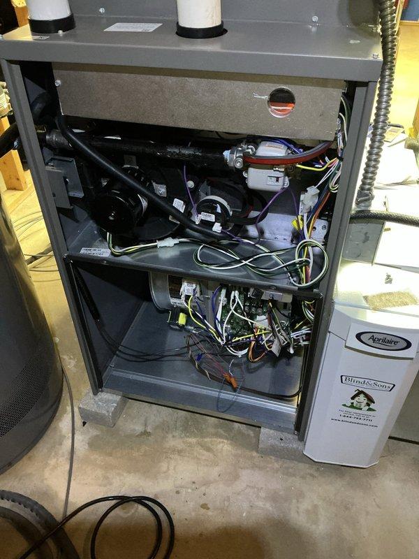 Performed a full seasonal tune-up on the Lennox gas furnace, including removal of the access panel, inspection of the inducer motor, blower assembly, control board, and wiring, along with verification of venting and PVC condensate/intake piping. Inspected the Aprilaire humidifier and drain line connections, confirmed normal system operation, and found no visible damage, rust, or leaks. Noted loose, unterminated wiring inside the lower compartment for follow-up.