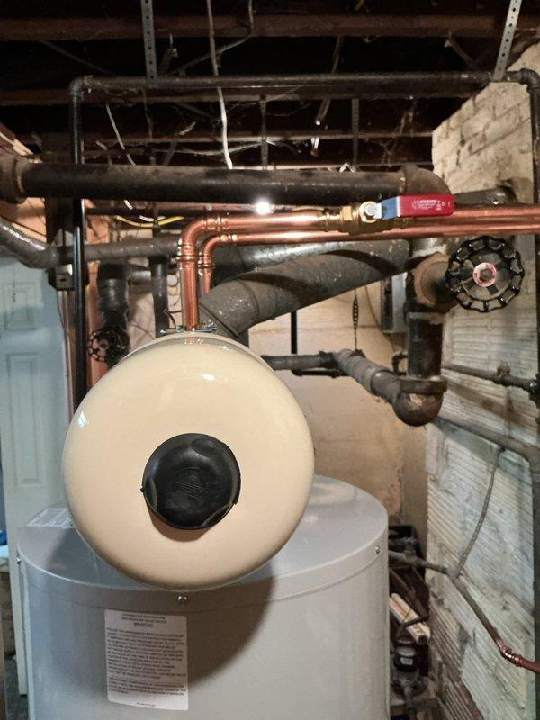 Removed and replaced the existing water heater with a new 40-gallon tall Bradford White unit, installing new water and gas shut-off valves and reconnecting the vent connector. Added strapping to properly support the gas and water supply lines, and installed a thermal expansion tank on the cold water line to protect against pressure buildup. The system was verified free of leaks, and the new tank carries a 6-year warranty.