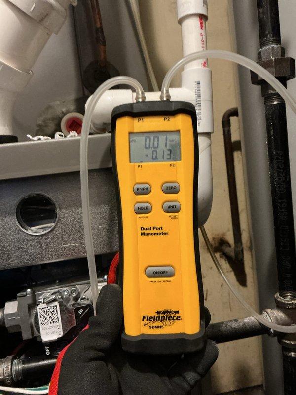 Performed scheduled heating maintenance on a 2-year-old gas furnace located in the basement. Verified temperature rise across the unit using a digital clamp meter with thermocouples (106.1°F supply vs. 73.1°F return) and checked static pressure with a dual-port manometer, confirming normal operation. Equipment is due for membership renewal.