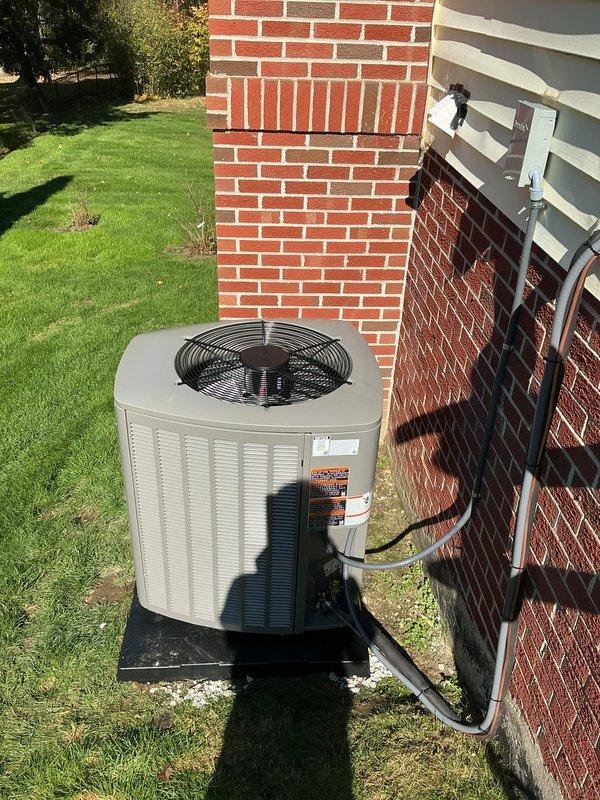 Completed installation of a new 90% AFUE gas furnace and matching air conditioning condenser as a complete system replacement. The outdoor condenser was set on a level pad with the electrical disconnect and conduit wired in, and the insulated refrigerant lines connected. System temperatures were measured with a multi-probe digital thermometer to verify proper operation.