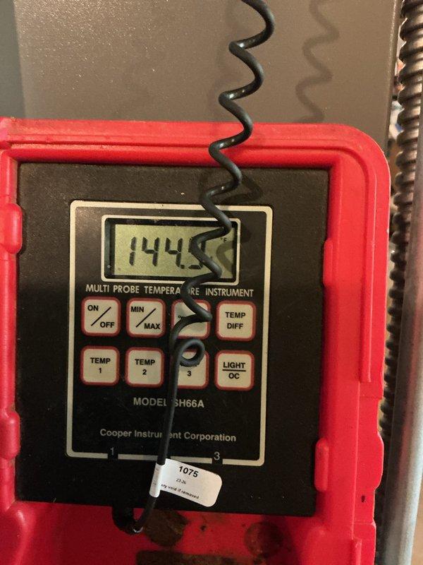 Completed installation of a new 90% AFUE gas furnace and matching air conditioning condenser as a complete system replacement. The outdoor condenser was set on a level pad with the electrical disconnect and conduit wired in, and the insulated refrigerant lines connected. System temperatures were measured with a multi-probe digital thermometer to verify proper operation.