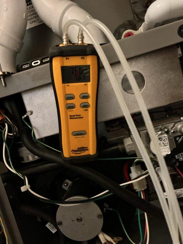 Performed annual maintenance on a 5-year-old gas furnace, including inspection of the burner compartment, gas valve assembly, inducer motor, wiring connections, and PVC intake/exhaust piping. Verified gas manifold pressure and checked pressure readings across the system using a dual port digital manometer to confirm proper combustion and airflow. Unit was left operating within normal parameters.