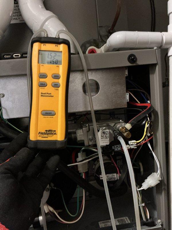 Performed annual maintenance on a 5-year-old gas furnace, including inspection of the burner compartment, gas valve assembly, inducer motor, wiring connections, and PVC intake/exhaust piping. Verified gas manifold pressure and checked pressure readings across the system using a dual port digital manometer to confirm proper combustion and airflow. Unit was left operating within normal parameters.