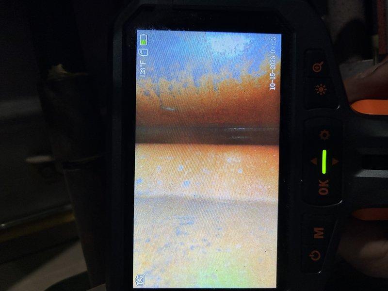 Responded to a no-heat call on a furnace of unknown age and performed a diagnostic inspection, including a borescope examination of the heat exchanger. The inspection revealed heavy corrosion, rust flaking, and scale buildup on the interior surfaces, indicating heat exchanger deterioration. The unit's condition and age make it unsafe and unreliable to operate, so replacement is recommended.