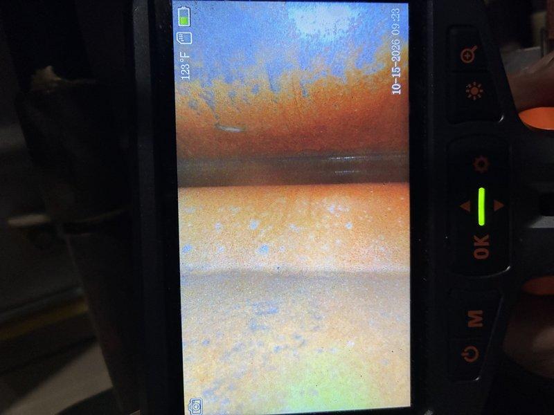 Responded to a no-heat call on a furnace of unknown age and performed a diagnostic inspection, including a borescope examination of the heat exchanger. The inspection revealed heavy corrosion, rust flaking, and scale buildup on the interior surfaces, indicating heat exchanger deterioration. The unit's condition and age make it unsafe and unreliable to operate, so replacement is recommended.