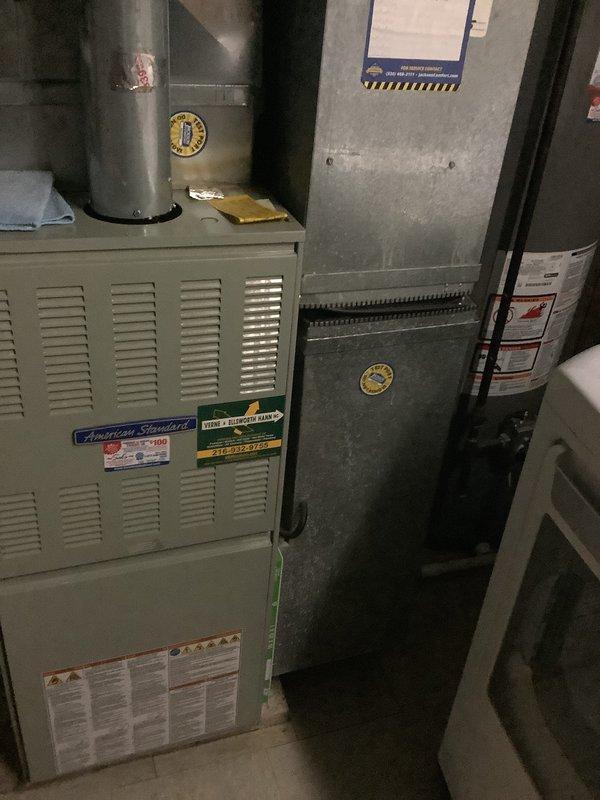 Performed an on-site evaluation of the existing Ameristar outdoor air conditioning condenser and American Standard gas furnace to assess system condition and scope a full split-system replacement. Inspected the condenser pad, surrounding clearances, and furnace, flue, and plenum configuration, and documented the equipment with photos for replacement estimating. Noted overgrown vegetation around the condenser and no obvious rust or physical damage at the furnace.