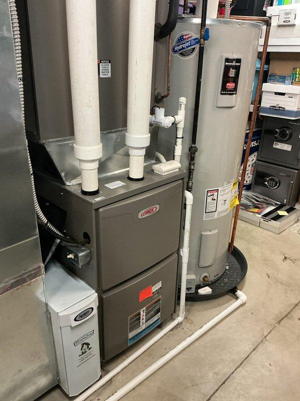 Performed scheduled heating maintenance on a Lennox gas furnace, inspecting the control board, wiring harnesses, and connectors and verifying electrical operation with a clamp meter. Checked the intake/exhaust PVC venting and condensate neutralizer drain assembly, finding no signs of burning, corrosion, or frost. System components were found in serviceable condition and operating normally.