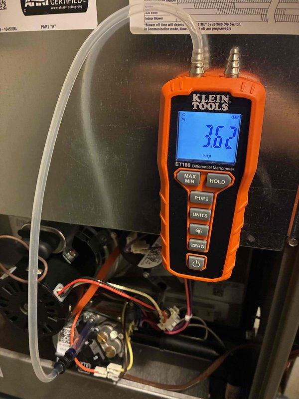 Performed a seasonal heating maintenance inspection on a 2-year-old furnace, including gas manifold pressure verification with a digital differential manometer (reading 3.62 in. w.c.). Inspected the blower assembly and squirrel-cage wheel, finding light dust accumulation with blades intact and no signs of rust or physical damage. Equipment is in good working condition with no repairs required.