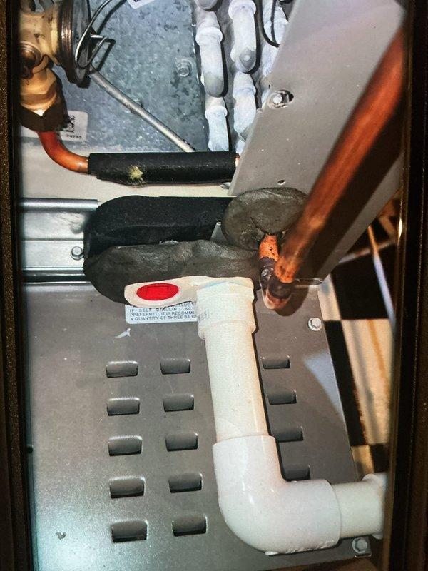 Performed seasonal heating maintenance on a 2-year-old furnace system, including inspection of the furnace and associated air handler components. Observed heavy frost and ice accumulation on the evaporator coil and expansion valve area, indicating a possible airflow restriction or refrigerant charge issue, and verified the condensate drain pan, PVC drain line, and refrigerant line insulation connections were intact with no visible rust or leaks. Recommend further diagnostics of the evaporator coil icing condition to determine root cause and prevent recurrence.