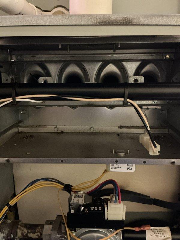 Performed annual heating maintenance on a 13-year-old gas furnace, including inspection of the gas valve assembly, burner section, inducer motor, and blower compartment, along with wiring, connectors, and limit/rollout switch. Noted accumulated dust and soot on the burners and cabinet floor, heat-discolored ignitor/flame sensor leads, and rust and corrosion on the gas pipe fittings, and recommended continued monitoring given the age of the unit. The customer is eligible to renew their maintenance plan.