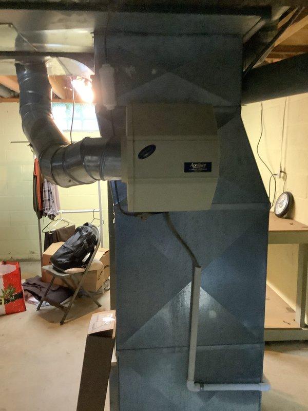 Performed an estimate for replacement of a 13-year-old Trane gas furnace after diagnosing a cracked heat exchanger, which poses a safety risk and warrants unit replacement. Inspected the existing installation, including PVC condensate/vent piping, flue connections, and the Aprilaire humidifier mounted on the supply plenum, and documented conditions to support the replacement quote.