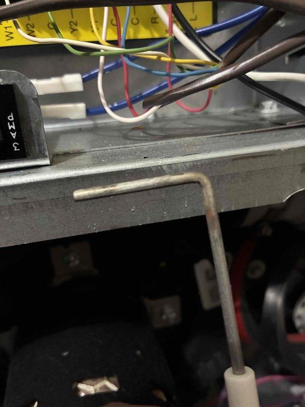 Performed a heating maintenance inspection on the furnace, including a review of the control board, low-voltage wiring, and terminal connections at the W1, W2, G, Y2, C, R, and L terminals, with wiring found properly routed and secured. Inspected the flame sensor and ignitor assembly, noting light surface corrosion on the probe, and checked the blower housing, condensate drain piping, and cabinet interior, with no signs of frost, breakage, or significant rust. System components were found in serviceable condition, with the minor corrosion on the sensor probe noted for monitoring.