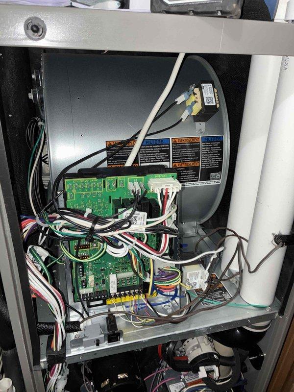 Performed a heating maintenance inspection on the furnace, including a review of the control board, low-voltage wiring, and terminal connections at the W1, W2, G, Y2, C, R, and L terminals, with wiring found properly routed and secured. Inspected the flame sensor and ignitor assembly, noting light surface corrosion on the probe, and checked the blower housing, condensate drain piping, and cabinet interior, with no signs of frost, breakage, or significant rust. System components were found in serviceable condition, with the minor corrosion on the sensor probe noted for monitoring.