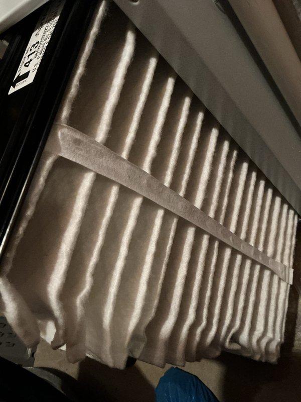 Performed recurring heating maintenance, inspecting the pleated air filter and finding it clean and in serviceable condition with no tearing or heavy debris loading. Measured system static pressure using a dual-port digital manometer to verify airflow performance, and noted staining on the condensate PVC piping for continued monitoring.