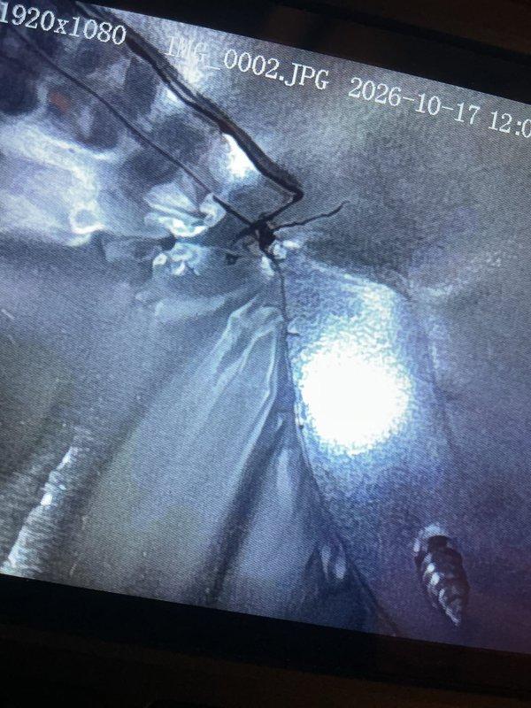 Performed seasonal cooling maintenance on the HVAC system, including a borescope inspection of the ductwork interior that revealed crumpled foil-faced insulation and debris within the cavity. Inspected the return air filter and found the pleated media heavily loaded with dust and debris, indicating restricted airflow and the need for replacement. System components were evaluated to confirm proper operation and efficiency.
