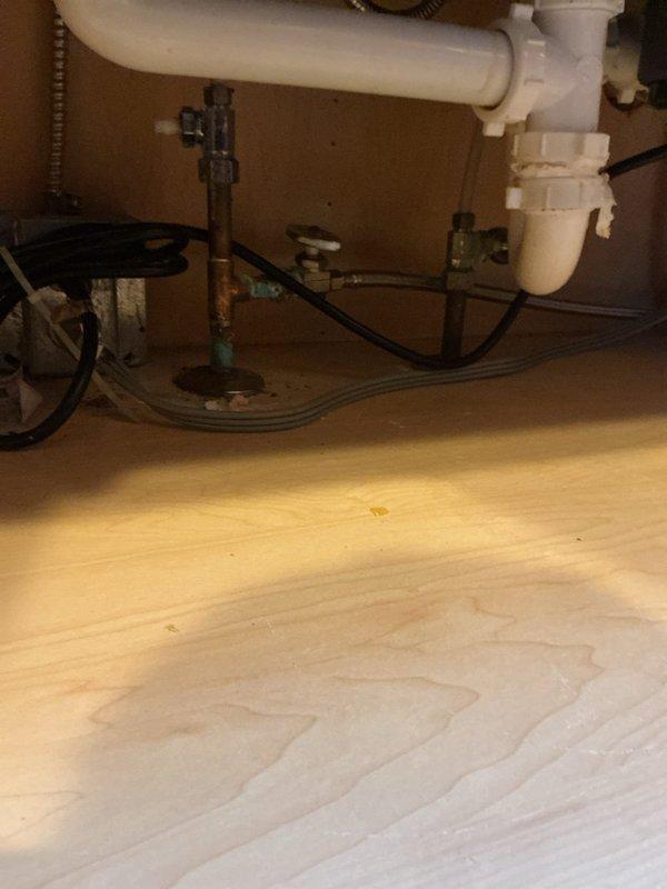 Responded to a failed water softener that ruptured during regeneration and sent sediment through the domestic water lines, leaving the kitchen sink without flow. Inspected the under-sink supply lines, shut-off valves, and drain assembly, and found corrosion at the copper riser joint and sediment staining in the basin. Flushed the affected lines and cleared the debris to restore water flow to the kitchen faucet.