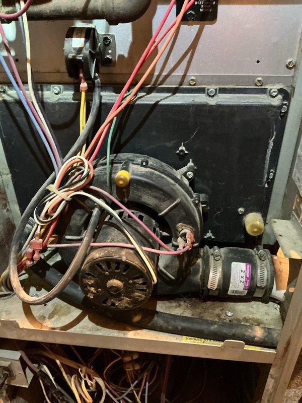 Diagnosed the 27-year-old gas furnace for a glowing component and short-cycling during heat calls, with the draft inducer assembly, control board, and surrounding wiring inspected and found dust-laden with aged, worn wiring. The glowing metal and clicking are consistent with the hot surface igniter cycling without establishing flame, and the sound heard during heat calls is consistent with the draft inducer running independently of the blower. Cleaned and inspected the affected components and verified safe operation of the ignition sequence.