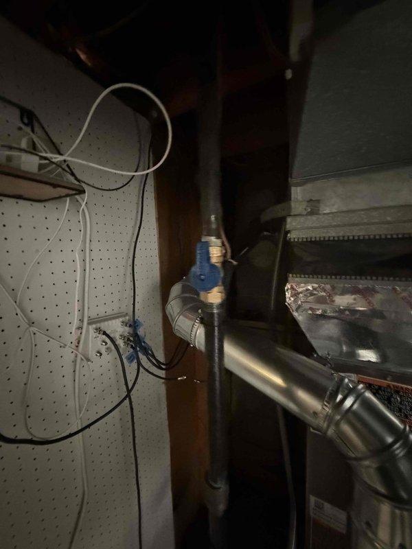 Installed a complete HVAC system consisting of an 80% AFUE gas furnace, matching air conditioning system, and whole-home humidifier. Connected the unit to the existing galvanized supply ductwork, reconnected the gas supply with a shutoff valve and insulated line, and wired low-voltage thermostat and control connections at the terminal junction. Routed condensate drainage to the existing floor drain and verified proper system operation.