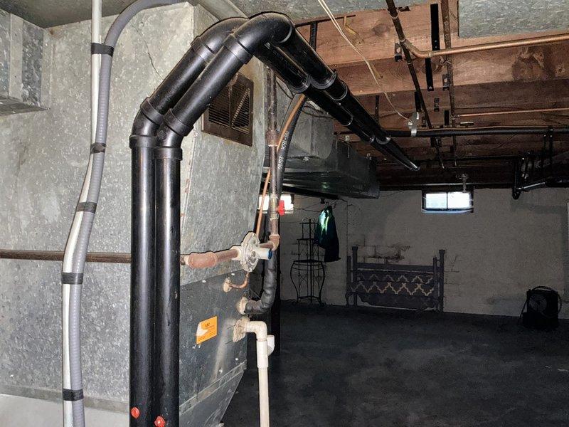 Performed a furnace replacement estimate in a basement affected by recent water intrusion, inspecting the existing Bryant Plus 95s Evolution Series 95% AFUE upright gas furnace, its galvanized plenum and ductwork, condensate and PVC drain lines, gas and refrigerant piping, and electrical connections. Documented the unit's condition, including surface staining, wear, and dust accumulation, and noted that the unit's proximity to the floor and the water exposure require evaluation for possible damage before proceeding with replacement recommendations.