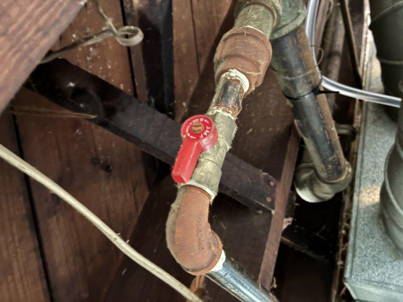 Responded to a no-heat call on a newly installed Lennox furnace with no blower operation. Inspected the gas supply piping and shutoff valve assembly at the furnace, noting heavy corrosion on the black iron fittings and valve connections. Verified the manual gas shutoff valves and supply line condition, and documented the findings with photos for further evaluation.