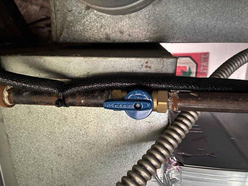 Responded to a no-heat call on a newly installed Lennox furnace with no blower operation. Inspected the gas supply piping and shutoff valve assembly at the furnace, noting heavy corrosion on the black iron fittings and valve connections. Verified the manual gas shutoff valves and supply line condition, and documented the findings with photos for further evaluation.