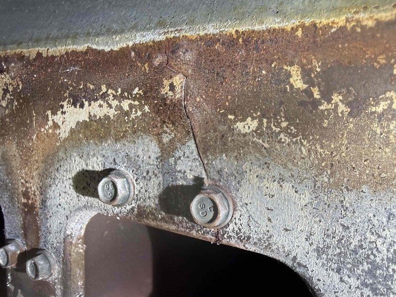 Performed a complimentary second-opinion inspection on a 30+ year-old furnace, with the homeowner present, to verify a previously reported cracked heat exchanger. Inspection revealed heavy corrosion and flaking on the heat exchanger and cabinet surfaces, with a visible crack near a fastener, and a blower wheel heavily contaminated with matted dust and debris restricting airflow. Findings and photo documentation were reviewed with the homeowner on-site.