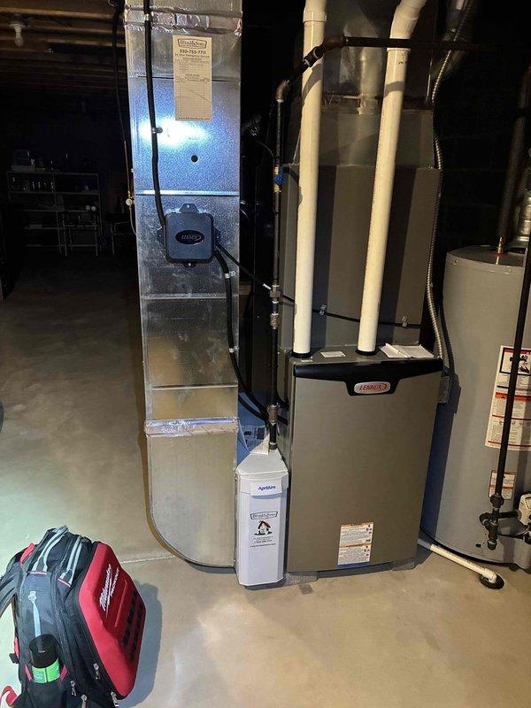 Performed seasonal heating maintenance on a Lennox gas furnace with an AprilAire humidifier, inspecting the furnace cabinet, PVC intake/exhaust piping, gas supply line, condensate drain, and associated ductwork for damage, corrosion, or leaks, with none found. Removed and inspected the flame sensor, and verified the system was in good working condition at completion.