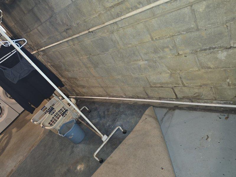 Installed a new 90% AFUE high-efficiency gas furnace, connecting it to the existing galvanized supply plenum and ductwork with a sealed access panel secured using foil tape at all joints. Routed and secured PVC venting and condensate drain piping along the wall to the utility area, ensuring proper termination and drainage.