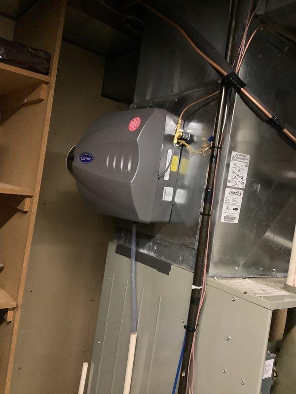 Performed an on-site replacement estimate for a 35-year-old Trane XL 90 gas furnace with a Carrier-branded humidifier mounted on the supply plenum. Inspected the unit, condensate drain piping, PVC venting, and surrounding ductwork, and documented the equipment with photos; no frost, rust, or significant damage was observed, though the unit's age warrants evaluation for replacement.