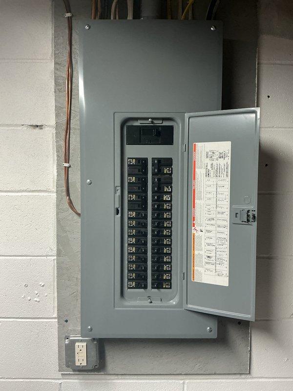 Evaluated the customer's request to connect a generator to the main electrical service. Inspected the basement main breaker panel, which was clean and free of corrosion or damage, and reviewed the exterior meter and service entrance conduit to determine the appropriate generator interconnection approach.