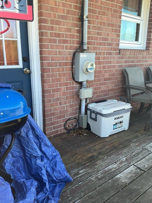 Evaluated the customer's request to connect a generator to the main electrical service. Inspected the basement main breaker panel, which was clean and free of corrosion or damage, and reviewed the exterior meter and service entrance conduit to determine the appropriate generator interconnection approach.