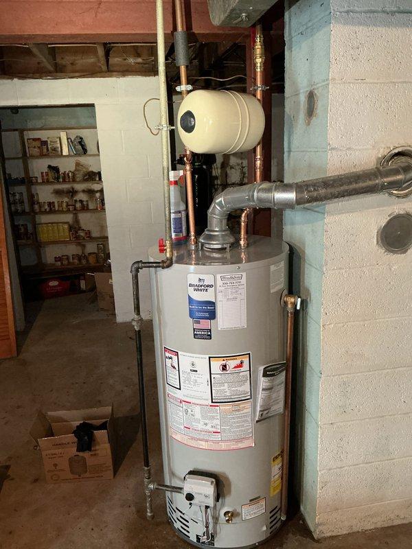 Installed a new 40-gallon Bradford White gas water heater with a 6-year manufacturer warranty, including a new ball valve, thermal expansion tank, and gas shut-off, and connected it to the existing flue, copper supply lines, and gas piping. Also replaced the lavatory faucet with a new Moen Chateau single-handle faucet in a chrome finish. Verified proper operation of both installations.