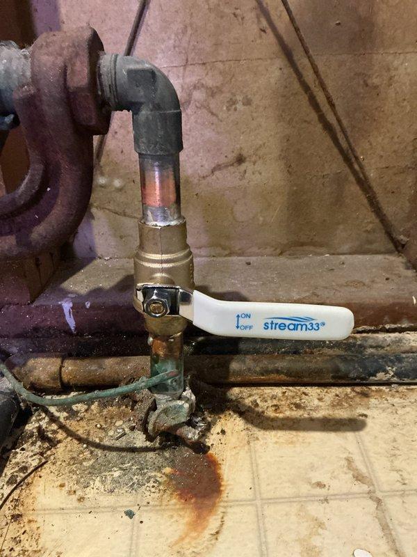 Coordinated a municipal water shutoff at the street, then cut out the leaking main shutoff valve ahead of the water meter and soldered in a new brass ball valve in its place. Installed a second new ball valve downstream of the meter, restoring dual isolation points on both sides of the meter. Existing meter spuds were left in place, and the corroded piping and fittings near the meter were not part of the scope of work.
