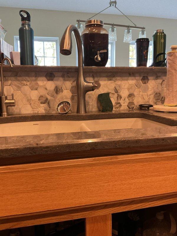 Relocated the bathroom shut-off valves to the proper position to allow for correct faucet installation, then secured the loose kitchen faucet by tightening its mounting hardware to the countertop, restoring a stable, leak-free connection. Verified proper operation of both fixtures.