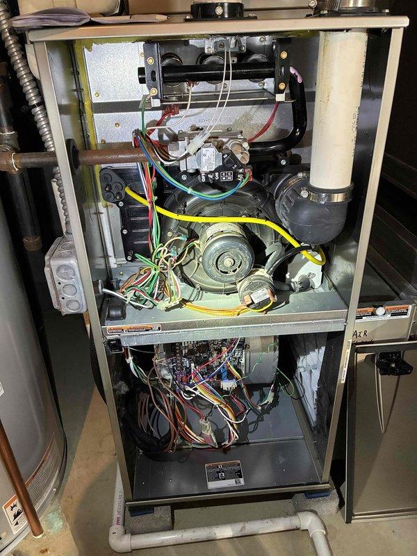 Performed a tune-up on a 13-year-old gas furnace, including removal of the front panel and inspection of the inducer motor, gas valve, pressure switch, venting, control board, and blower assembly. Removed and inspected the flame sensor, which showed tarnish and discoloration, and cleaned it to restore reliable flame sensing. Wiring harnesses were observed to be loosely bundled, and no frost, rust, or cracks were found on the unit.