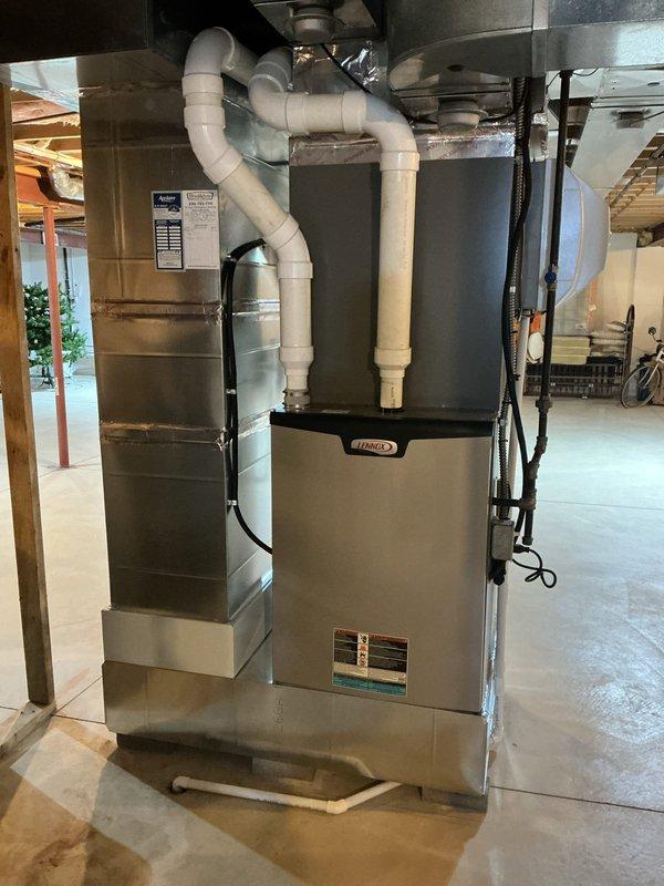 Performed scheduled preventive maintenance on a Lennox gas furnace, inspecting the cabinet, PVC intake/exhaust piping, condensate drain line, supply plenum, and ductwork for leaks, corrosion, and damage. Inspected the SureLight integrated control board, wiring harnesses, terminal connections, capacitors, and 3-amp fuse, finding no signs of frost, rust, or physical damage. The unit was left in clean, proper working condition.