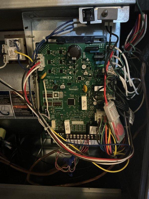 Performed scheduled preventive maintenance on a Lennox gas furnace, inspecting the cabinet, PVC intake/exhaust piping, condensate drain line, supply plenum, and ductwork for leaks, corrosion, and damage. Inspected the SureLight integrated control board, wiring harnesses, terminal connections, capacitors, and 3-amp fuse, finding no signs of frost, rust, or physical damage. The unit was left in clean, proper working condition.