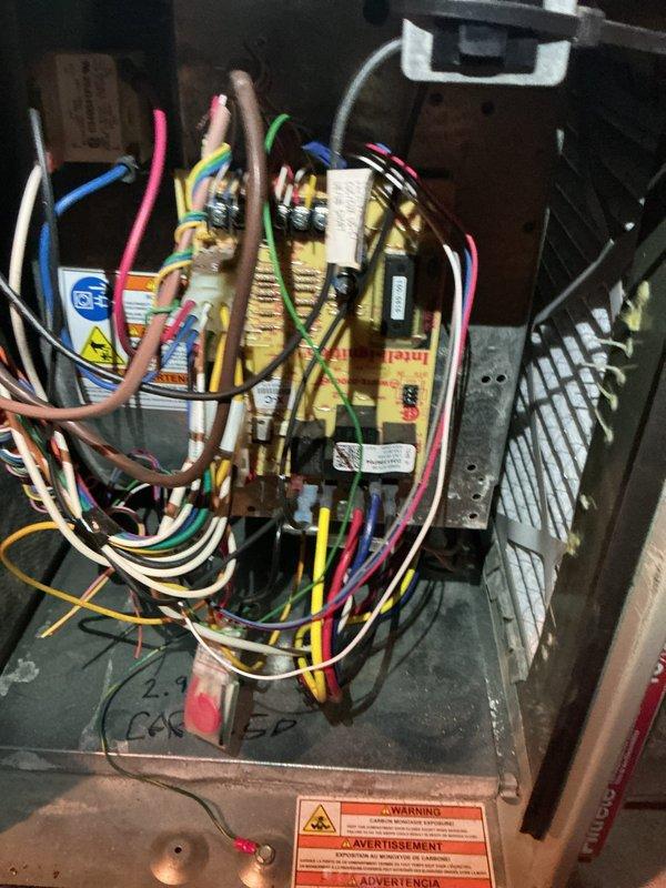 Performed a recurring seasonal heating maintenance visit on a Trane XR80 gas furnace, including inspection of the cabinet, flue connection, and control board wiring harness. Observed dust and debris buildup on interior surfaces and the blower/filter section, and verified the integrity of the electrical connections and safety labeling. Unit was left in operational condition.