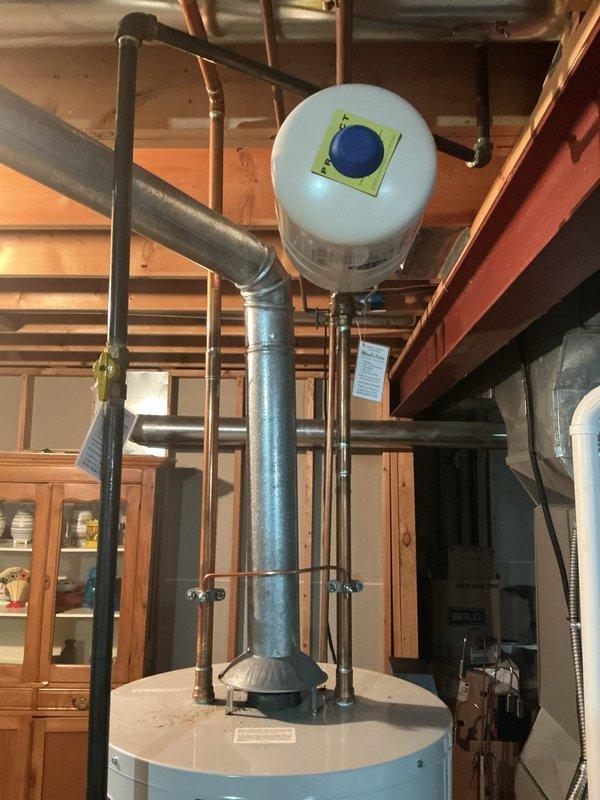 Provided an estimate for replacement of the existing gas-fired tank-style water heater, inspecting the unit, its galvanized flue venting, gas supply with shutoff valve, copper supply piping, and existing expansion tank. The heater and associated components showed no visible signs of leaks, corrosion, or frost damage, and the installation was documented photographically to support the replacement quote.