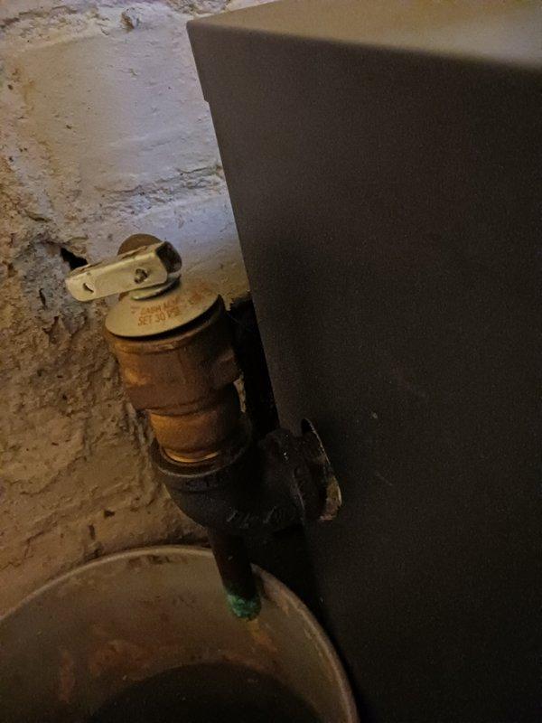 Performed a tune-up on a 20-year-old hot water boiler, including inspection of the circulator pump, air separator, expansion tank, flue, and associated piping and controls. Replaced the brass 30 PSI pressure relief valve at the customer's request, verified the test lever and discharge pipe, and noted green corrosion on the discharge piping and copper joints that should be monitored.