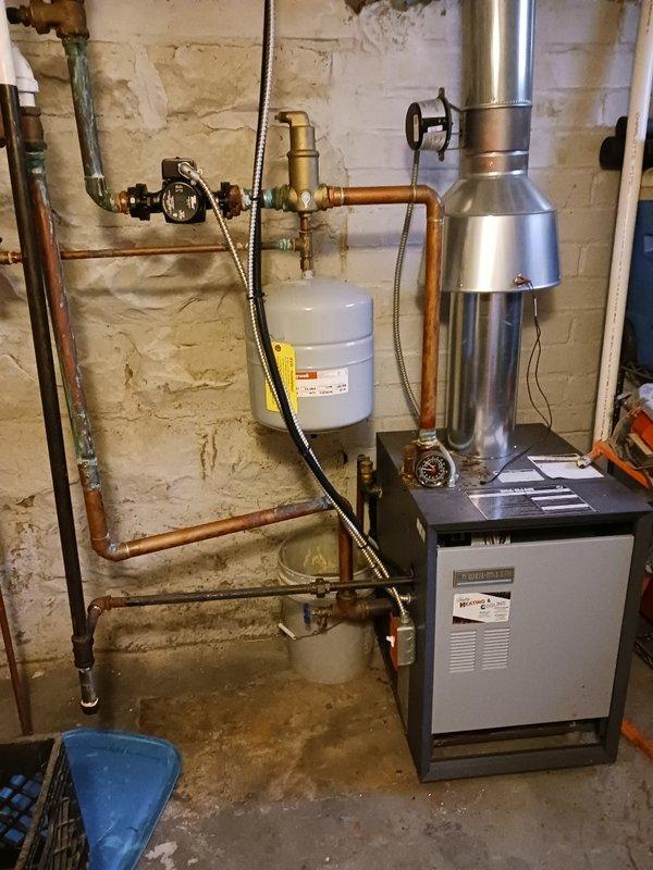 Performed a tune-up on a 20-year-old hot water boiler, including inspection of the circulator pump, air separator, expansion tank, flue, and associated piping and controls. Replaced the brass 30 PSI pressure relief valve at the customer's request, verified the test lever and discharge pipe, and noted green corrosion on the discharge piping and copper joints that should be monitored.