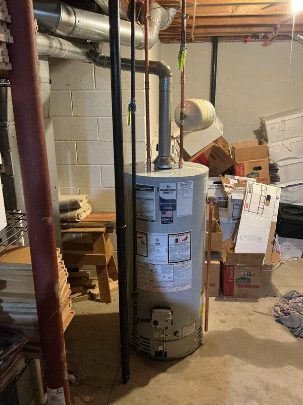 Replaced the existing basement gas water heater with a new 40-gallon short-profile unit, including installation of a new thermal expansion tank to protect the closed-loop system from pressure buildup. Reconnected the water supply, gas, and flue venting using the water heater installation kit, reused the serviceable shutoff ball valve, and confirmed proper operation with no leaks.