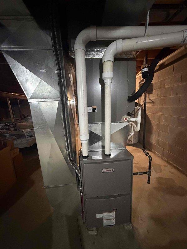 Installed a new Lennox 90%+ high-efficiency gas furnace in the basement, connecting it to the existing galvanized supply plenum and ductwork with a sealed transition. Piped the PVC intake and exhaust venting, routed the condensate drain line to the floor drain, and reconnected the gas supply with black iron piping and fittings. Completed electrical connections and verified proper startup, combustion, and operation.